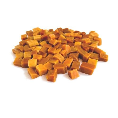 A pile of small, square-shaped caramel candies on a white background.